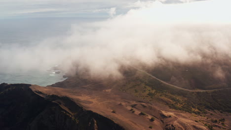 Cinematic-aerial-drone-shot-of-clouds-traveling-high-over-Capelinhos-Volcano-in-the-Faial-island-in-the-Azores---Portugal