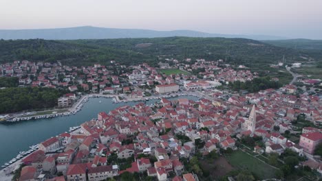 Historical-Croatian-town-of-Stari-Grad-Hvar-in-Dalmatia,-aerial-circle-pan-shot
