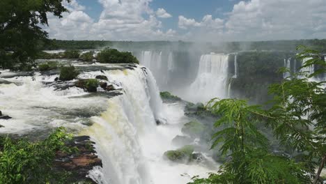 Beautiful-Falling-Clear-Water-in-Iguazu-Falls,-Brazil,-South-America,-High-Above-View-of-Large-Waterfall-Dropping-into-Rainforest-Plunge-Pool-in-Colourful-Green-Jungle-Landscape