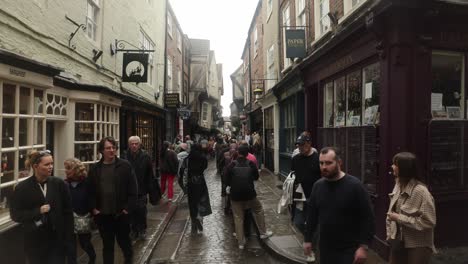 Hand-held-shot-of-people-waiting-to-enter-the-Ghost-Merchants-in-the-Shambles,-York