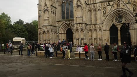 Hand-held-shot-of-tourists-queuing-and-taking-photographs-outside-of-York-Minster