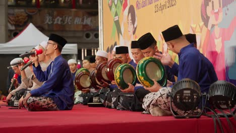 Group-of-Muslim-Men-sitting-and-devoutly-singing-praises-and-playing-gong-on-stage