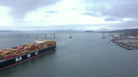 A-large-cargo-ship-in-Astoria,-Oregon-carrying-many-containers