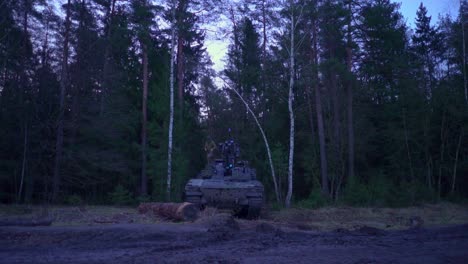 Soldier-getting-out-of-Nato-Leopard-tank-early-morning-in-forest