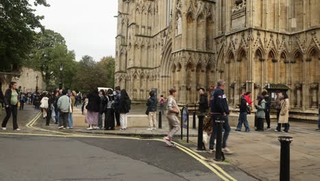 Hand-held-shot-of-tourists-queuing-outside-York-Minster-waiting-to-get-inside
