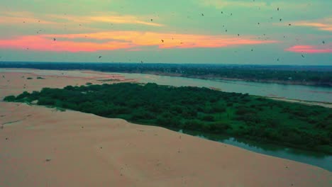Distant-sky-of-beautiful-colors-and-amazing-footage-of-birds-migrating,-aerial