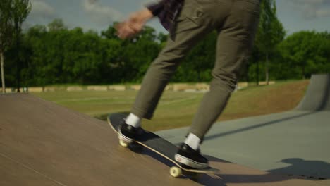 Male-skateboarder-doing-a-backside-kick-flip-at-a-skatepark