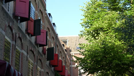 Brick-Exterior-With-Red-Shutters-Of-Weeshuis-Gouda-Hotel-In-Gouda,-Netherlands