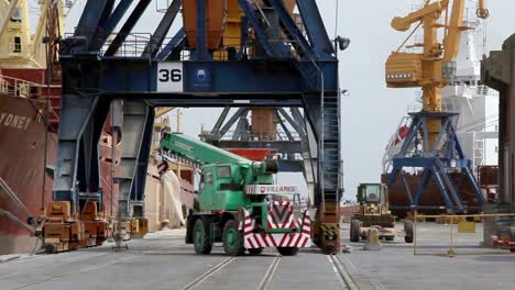 Vehicles-and-machinery-moving-around-the-dock-at-the-Port-of-Santos,-Brazil