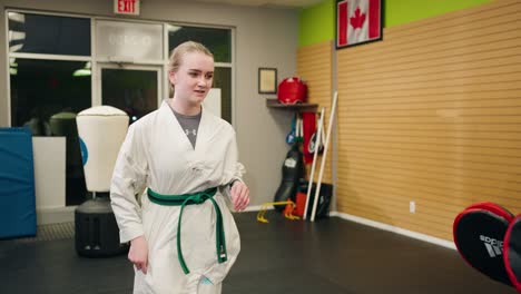 A-Young-Teenage-Girl-Gets-Hyped-Psyched-Up-to-Double-Kick-Jump-Spar-with-Martial-Arts-Taekwondo-Black-Belt-Master-in-Training-at-a-Canadian-Karate-Gym-Practice-Center