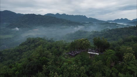 Punthuk-Setumbu-Tourist-Spot-with-Sunrise-Morning-Fog-in-Bali-Magelang-Mountains,-Aerial-Orbit