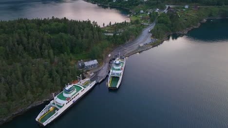 Vehicles-drive-onto-ferry-at-Dragsvik-Fergeleie,-Balestrand,-Sognefjord-aerial