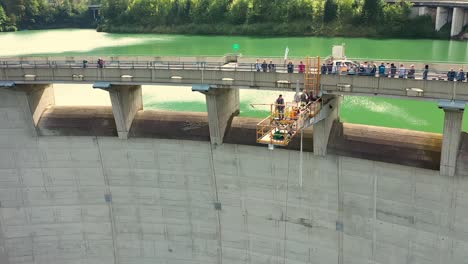 People-watching-Person-on-bungee-jumping-platform-on-a-high-dam-in-Klaus-an-der-Pyhrnbahn,-Austria