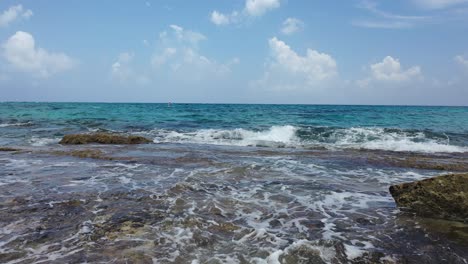 Panorama-of-Caribbean-Blue-Sea-Crashing-Against-Rocky-Shoreline