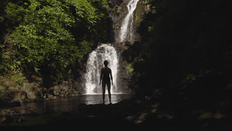 Woman-Stands-in-Front-of-Rha-Waterfall-on-Isle-of-Skye-Scotland-4K
