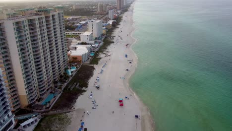 Beach-Aerial-Panama-city-beach-Florida-Luxurious-tropical-beach-resort-or-hotel-with-beach-service-colorful-umbrellas-on-the-beachfront,-Aerial-view-drone-camera-video