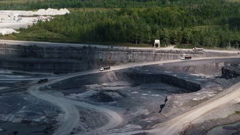 Wide-angle-establishing-shot-trucks-and-lorries-driving-in-quarry-mine