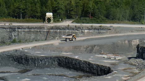 Dump-truck-driving-through-quarry-with-coal-fossil-fuel-load