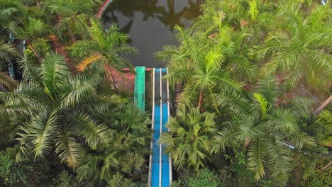 Topdown-view-of-old-abandoned-waterslides-at-Thuy-Tien-lake-Abandoned-Water-Park,-aerial