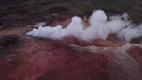 Thermal-steam-vent-flowing-in-red-volcanic-lava-field-of-Gunnuhver