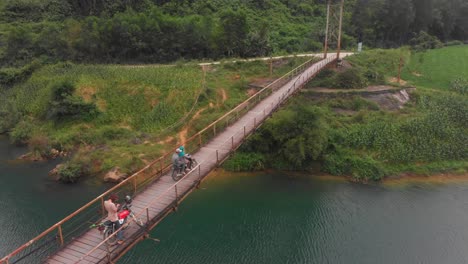 Old-suspension-bridge-over-Con-river-at-Phong-nha-at-Vietnam,-aerial
