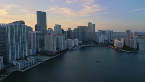Aerial-backward-shot-of-Brickell-Bay-at-sunset,-Miami,-Florida,-USA