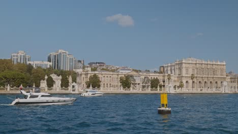 Leisure-boats-cruise-Bosphorus-with-Dolmabahce-palace-shoreline-backdrop