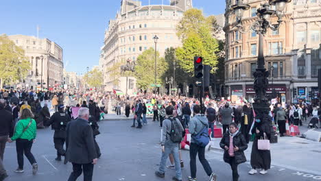 Bustling-urban-scene-showing-a-large-gathering-of-people-in-a-city-square-or-street-intersection-in-London-UK
