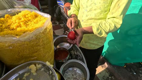 A-shopkeeper-is-processing-tomatoes-to-make-a-mixture