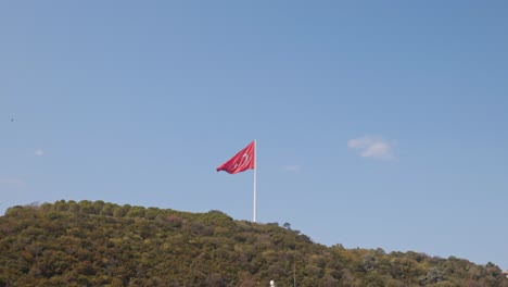 Turkish-red-flag-flies-on-top-of-hilltop-on-Bosphorus-scenic-coastline