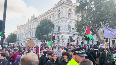 Pro-Palestinian-followers-demonstrate-on-London-streets,-marching-with-slogans-and-flags-inscribed
