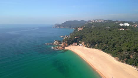 spectacular,-Mediterranean-beach-on-the-Costa-Brava-of-Gerona-in-Spain,-European-tourism,-forest,-leafy,-Arenas-beach,-yellow-and-water,-transparent-turquoise-blue