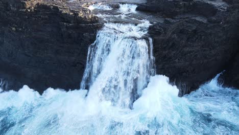 Close-drone-footage-of-the-Bøsdalafossur-Waterfall-near-the-Leitisvatn-Lake,-aka-the-Floating-Lake,-on-the-Vagar-island-in-the-Faroe-Islands