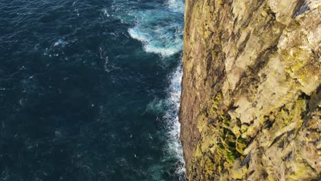 Drone-footage-following-a-very-steep-cliff-on-the-Vagar-island-in-the-Faroe-Islands