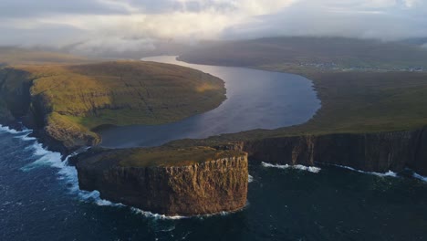 Very-far-circular-drone-footage-of-the-Leitisvatn-Lake,-aka-the-Floating-Lake,-on-the-Vagar-island-in-the-Faroe-Islands