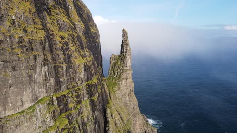 Drone-footage-passing-near-the-Witch-Finger-at-Sandavagur-on-the-Vagar-island-in-the-Faroe-Islands