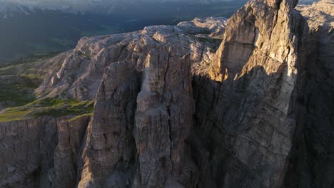Aerial-view-of-the-Dolomites'-jagged-peaks,-illuminated-by-the-soft-morning-glow-shortly-after-sunrise