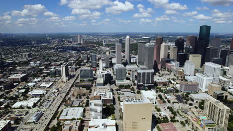 Aerial-tracking-shot-overlooking-the-cityscape-of-downtown-Houston,-sunny-TX,-USA