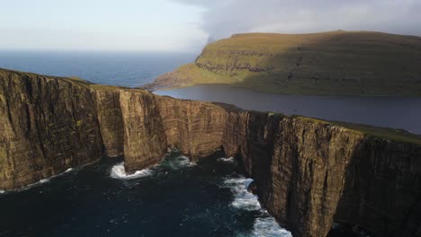 Drone-footage-with-an-unusual-angle-of-the-Leitisvatn-Lake,-aka-the-Floating-Lake,-on-the-Vagar-island-in-the-Faroe-Islands