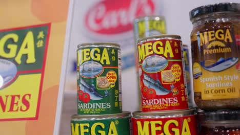 Cans-of-Philippine-Sardines,-Mackerel,-and-Tuna-on-display-booth-during-food-festival-exhibition