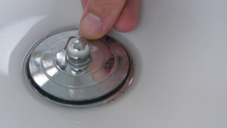 Close-up-slow-motion-shot-of-plug-hole-hands-being-filled-up-with-bubbles-water-sink-basin-bowl-bathroom-kitchen-personal-hygiene-washing-4K