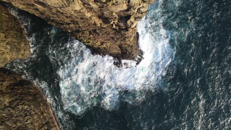 Static-top-down-drone-footage-of-a-very-steep-cliff-on-the-Vagar-island-in-the-Faroe-Islands