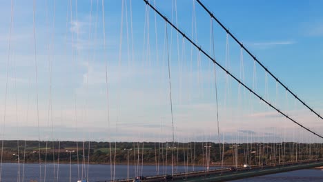 A-cinematic-journey:-Humber-Bridge-takes-the-spotlight,-with-cars-beneath-the-setting-sun