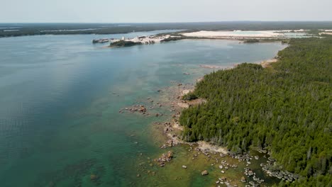 Aerial-view-of-quarry-and-wilderness-coastline,-Les-Cheneaux-Islands,-Michigan