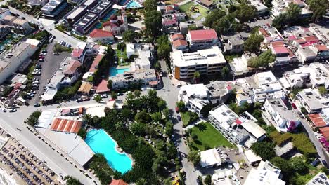 Hotels-and-resort-of-small-Crete-island-town,-aerial-drone-view