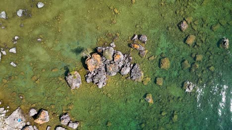 Aerial-topdown-of-large-boulders-in-lake-huron-coastline