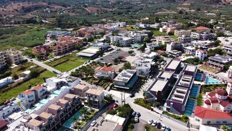 Panoramic-view-of-Crete-resort-town,-aerial