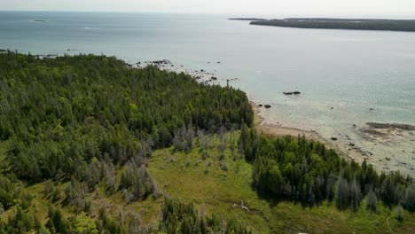 Aerial-view-of-forested-wilderness-coastline---Les-Cheneaux-Islands,-Michigan,-Lake-Huron