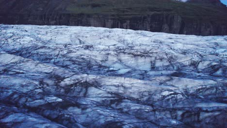 Aerial:-Circle-flyover-of-glaciers-serpentine-path-with-deep-crevasses-and-jagged-ice-formations,-evidence-of-climate-change-impact-on-the-constant-movement-and-transformation-of-this-natural-wonder