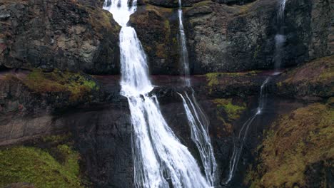 Aerial:-Crane-shot-ascending-up-Rjukandafoss-waterfall,-a-hidden-treasure-amidst-Iceland's-pristine-wilderness